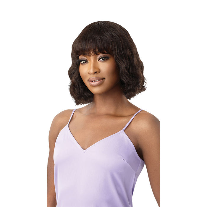 OUTRE unprocessed human hair wig short wavy bob with bangs on model wearing lavender camisole